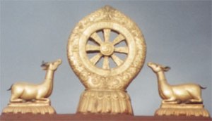 Wheel and dear above a Buddhist temple. Photo © Lisa Daix Wheel and dear above a Buddhist temple. Photo © Lisa Daix