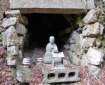 A statue of Kobo Daishi (774–835) guards a tiny hollow at Sankaku-ji representing the cave at Cape Muroto