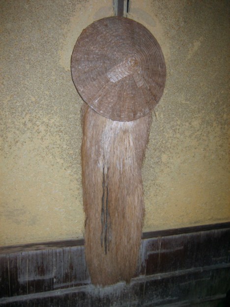 Grass raincoat and hat. Photograph © @KyotoDailyPhoto