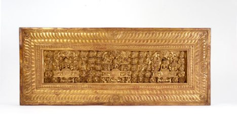 Gilt wood carving, red and black pigment