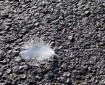 White feather on the pavement.
