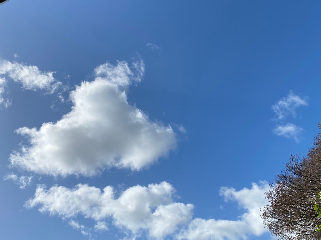 Clouds drifting in a blue sky.