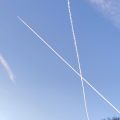 Aircraft contrails crossing in a clear sky.