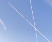 Aircraft contrails crossing in a clear sky.