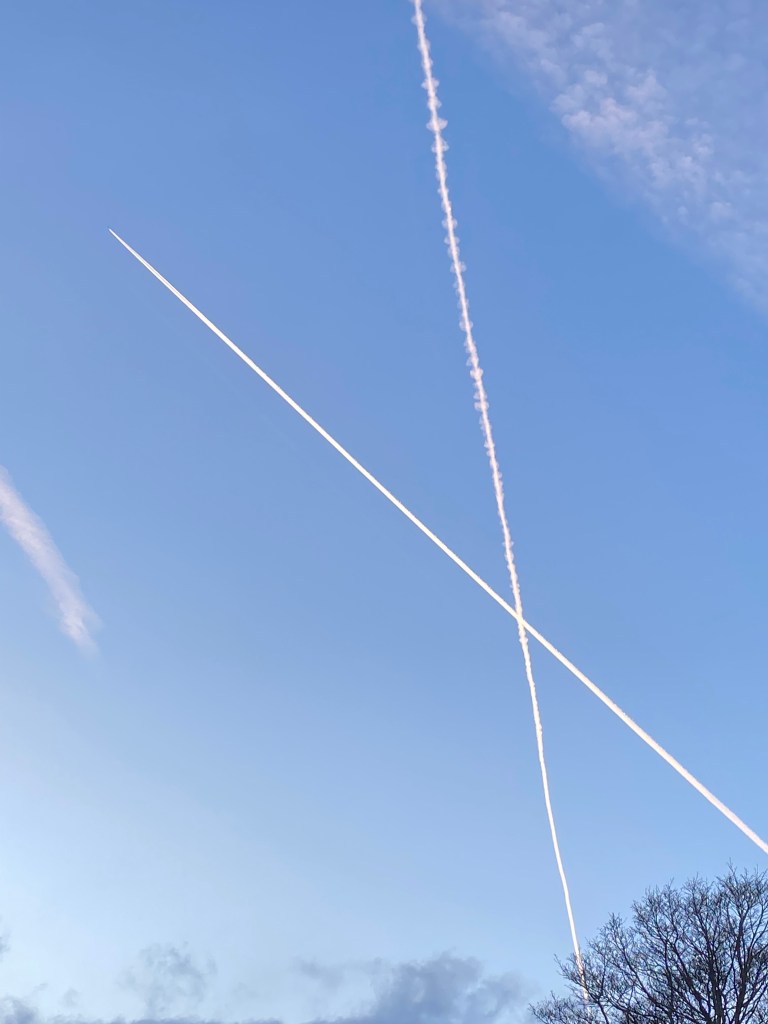 Aircraft contrails crossing in a clear sky.