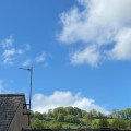 Sharpham Hill behind a rooftop.