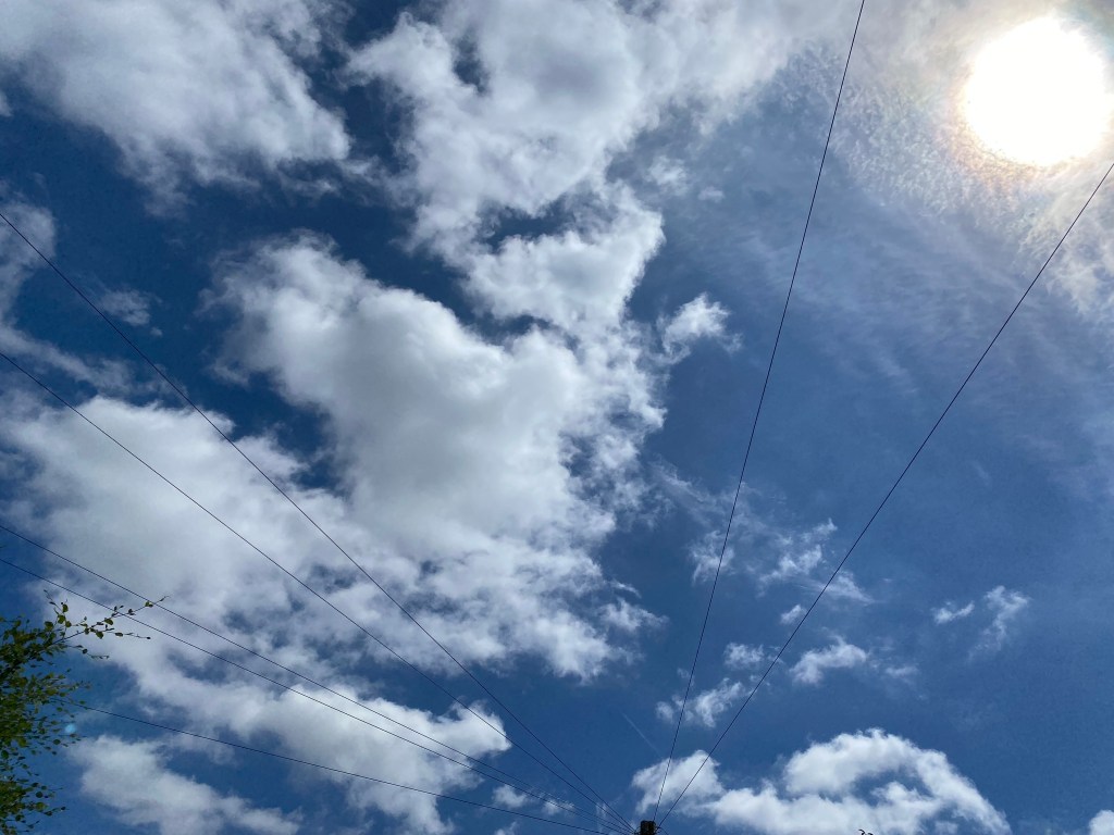 Clouds above some telephone lines.