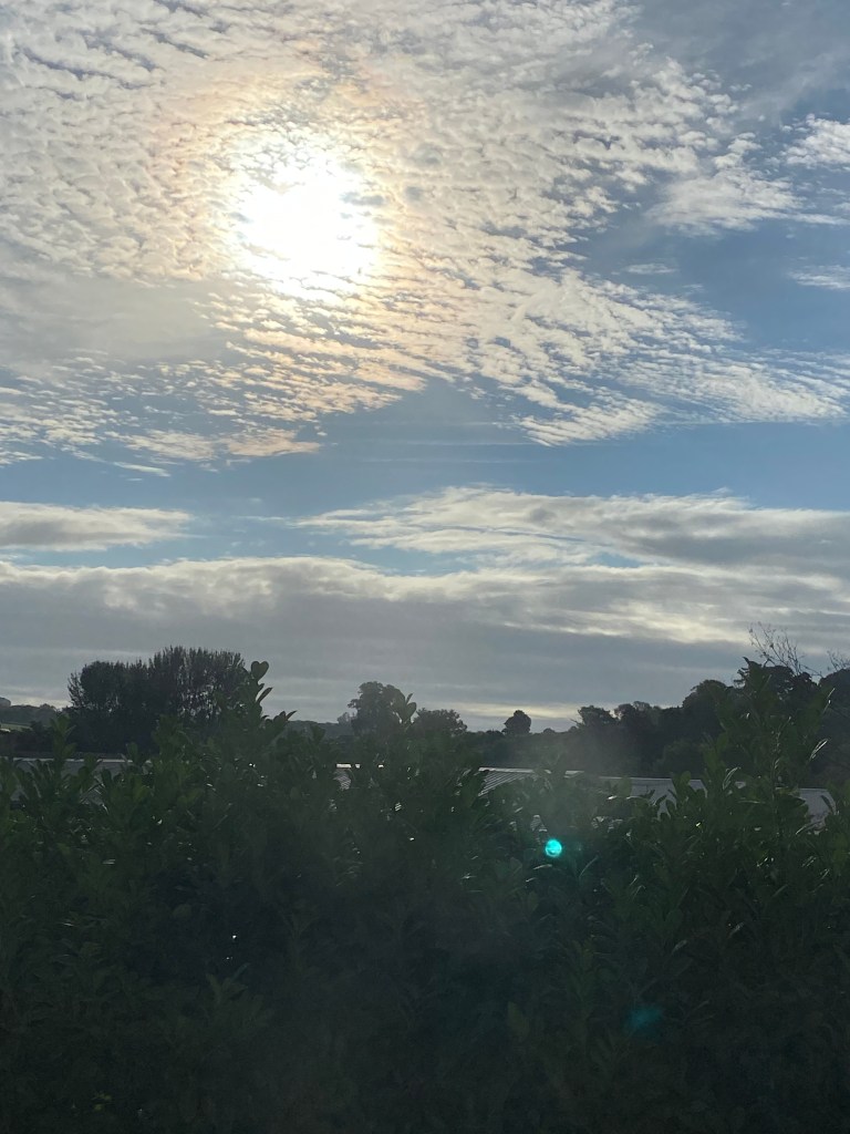 Early Sun breaking up the soft clouds.