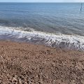 Wave breaks on the Teignmouth beach.