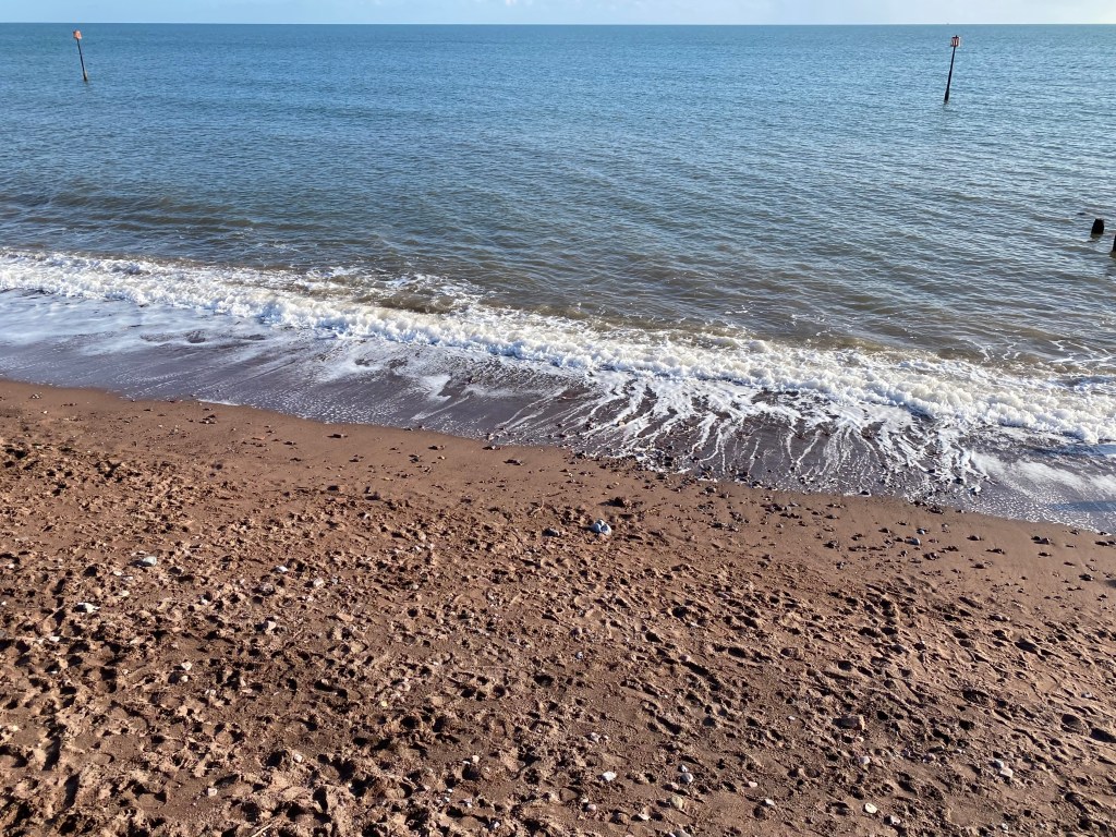Wave breaks on the Teignmouth beach.