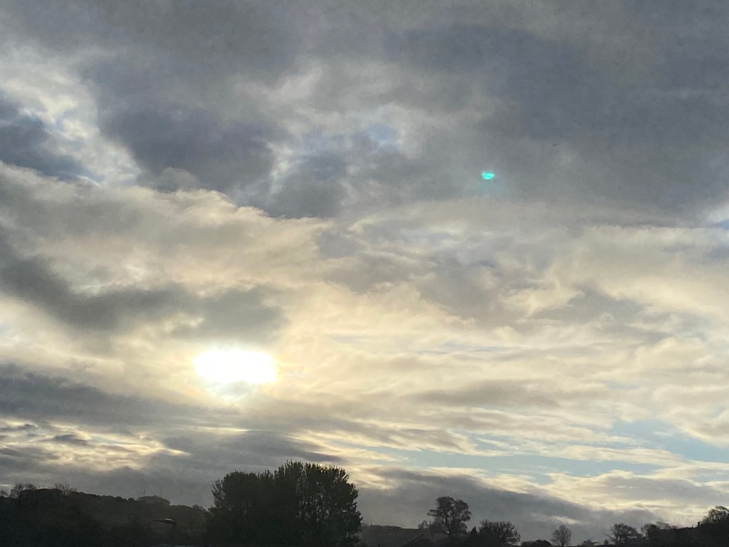 The early morning sun filtered through a cloudy sky.