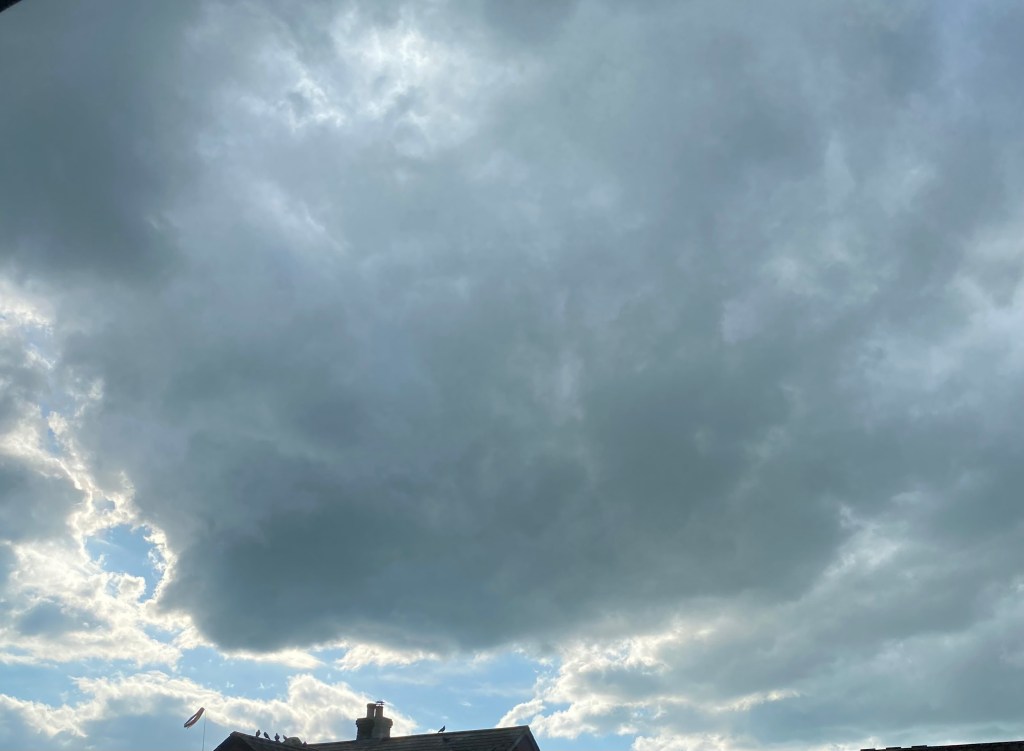 Dark cloud over a bright sky.