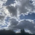 Grey clouds in a blue sky. Morning Meditation: Lot of money worries in the world today — may all beings find their inner treasure and be well and happy.