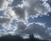 Grey clouds in a blue sky. Morning Meditation: Lot of money worries in the world today — may all beings find their inner treasure and be well and happy.